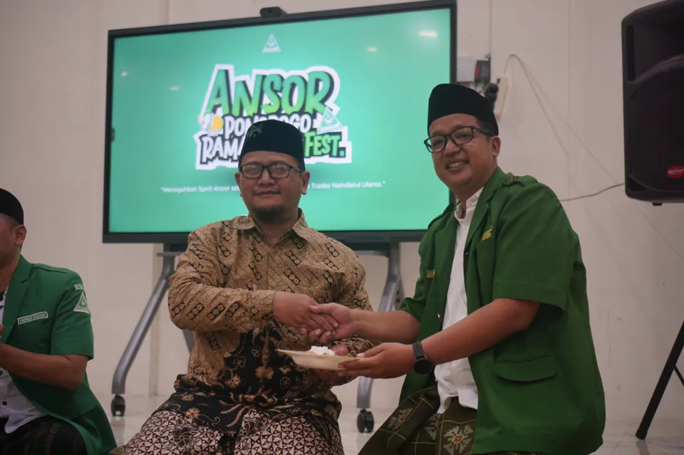 Penyerahan simbolis dalam Megengan dan Ruwahan Akbar PC GP Ansor Ponorogo di Graha PCNU Ponorogo, berlatar layar Ansor Ponorogo Ramadhan Fest